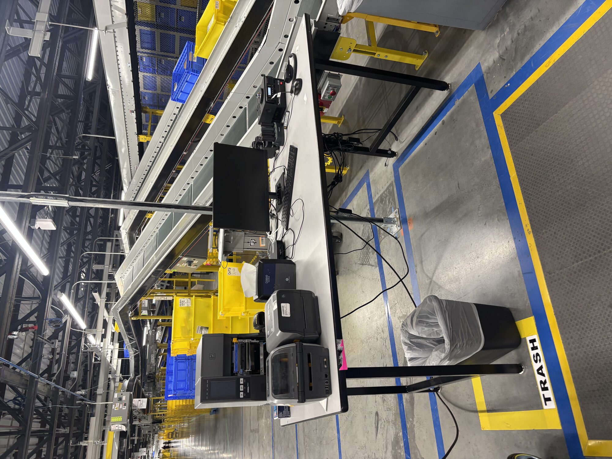 Wide hero shot of an Amazon fulfillment center floor